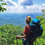 Female hiker overlooks mountain vista from the Appalachian Trail.